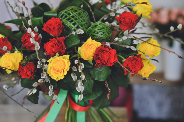 Close up photo of bouquet of yellowroses, red roses and willow b - 写真・画像