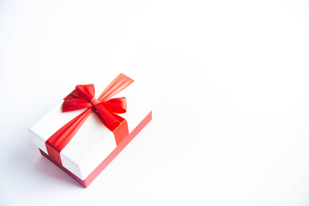 Beautiful Christmas gift box with red ribbon on isolated background. Happy New Year and merry christmas.  - Photo, Image