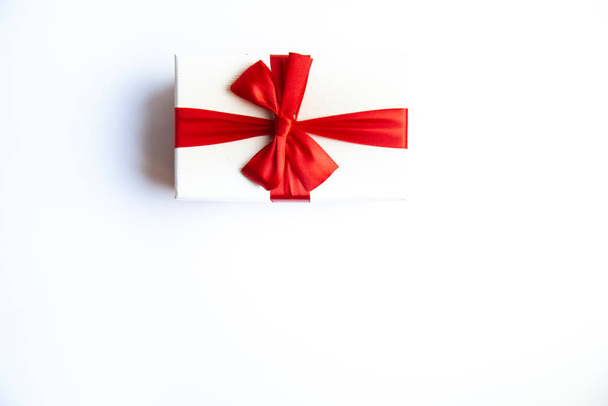 Beautiful Christmas gift box with red ribbon on isolated background. Happy New Year and merry christmas.  - Foto, Imagen