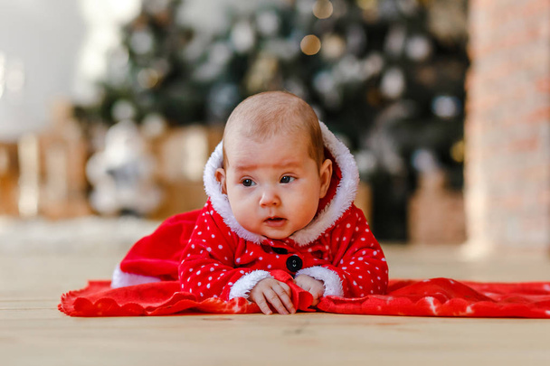 Baby girl in red New Year's dress - Фото, изображение