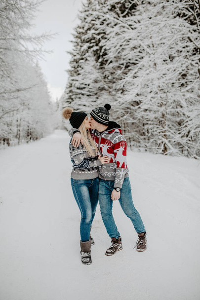 happy couple enjoying in the snowy winter forest . Christmas mood.   - Photo, image