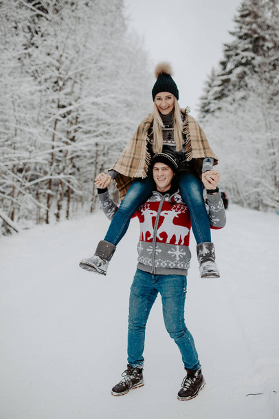 happy couple enjoying in the snowy winter forest . Christmas mood.   - Foto, afbeelding