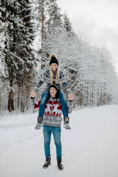 happy couple enjoying in the snowy winter forest . Christmas mood.   - Photo, image