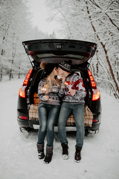 couple in love sitting in car trunk  - 写真・画像
