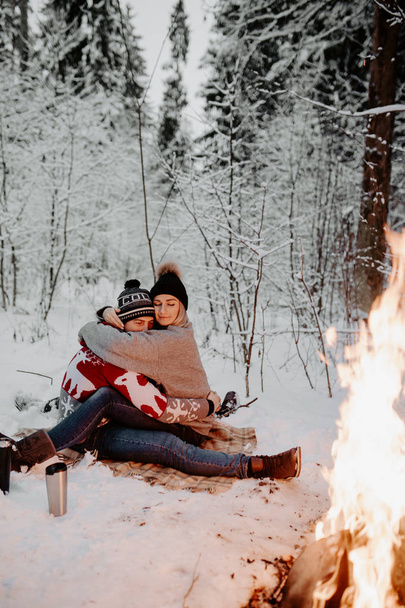 happy couple enjoying in the snowy winter forest . Christmas mood.   - Фото, изображение