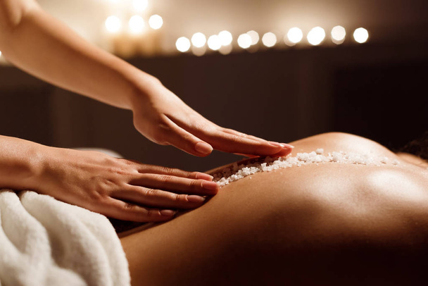 Spa concept. Woman receiving salt back massage - Zdjęcie, obraz