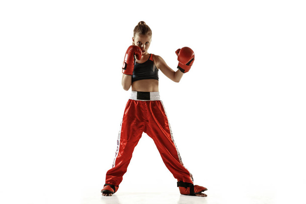 Young female kickboxing fighter training isolated on white background - Foto, Bild