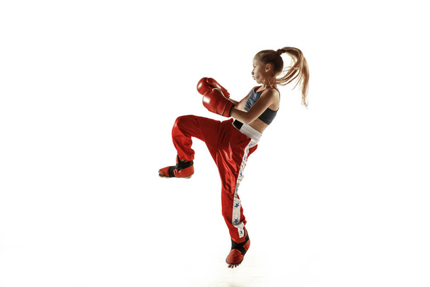 Young female kickboxing fighter training isolated on white background - Photo, Image
