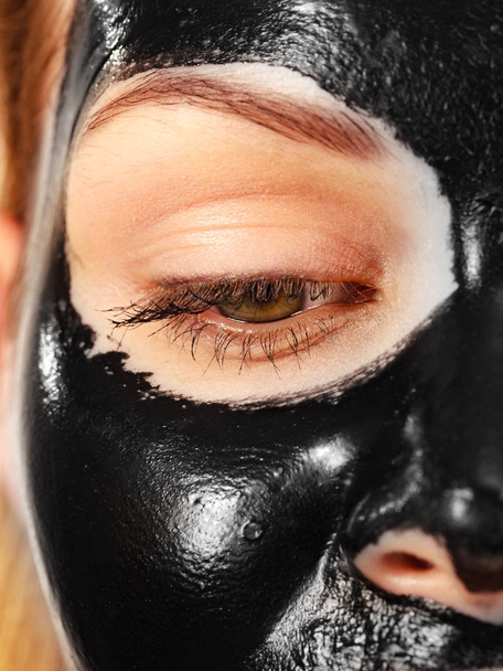 Girl black carbo peel off mask on face - Фото, зображення