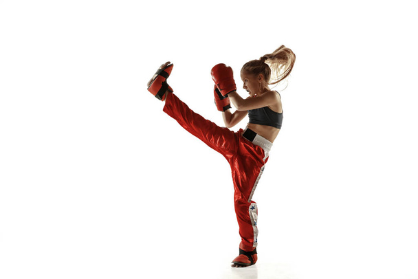 Young female kickboxing fighter training isolated on white background - Фото, изображение