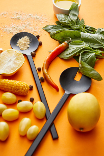 Organic vegetables with lemons and basil on orange background - Photo, Image