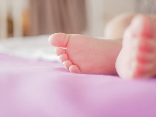 little baby feet. Theres nothing quite so sweet as tiny little baby feet. Little baby boy on bed. Close up. Space for copy. - Photo, Image