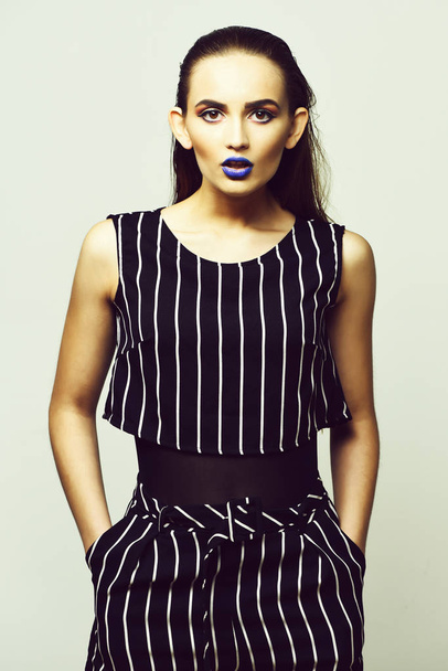 Pretty girl in striped suit with blue lips - Foto, Imagen