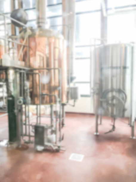 ぼやけた画像は、テキサス州ダラス近郊の地元レストランのフルワーキング醸造所のホップ。標準的なビールスタイルと季節のビールで発酵した光沢のあるタンクの列 - 写真・画像