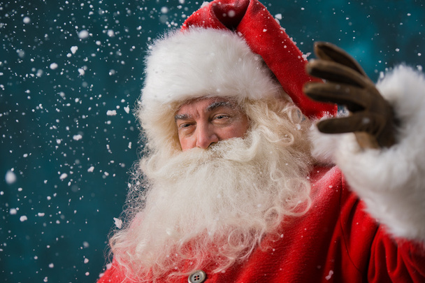 Photo of happy Santa Claus outdoors in snowfall - Fotó, kép