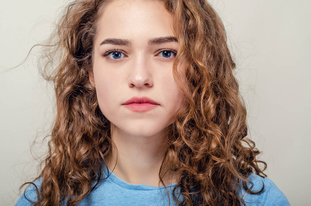 Portrait of beautiful young girl, close-up. Curly hair. Playing hair - Photo, Image