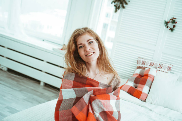 A beautiful young Russian woman in a red plaid - Photo, Image
