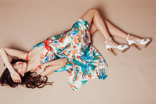 girl in colored dress rests with the floor smile - Фото, изображение
