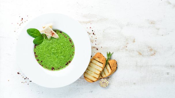 Spinach puree soup in a plate. Top view. Free copy space. - Foto, Bild