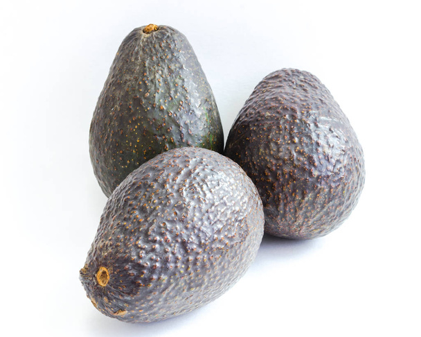 Three fresh whole avocados isolated on white background. Ripe organic Persea Americana, healthy fat fruits - Photo, Image