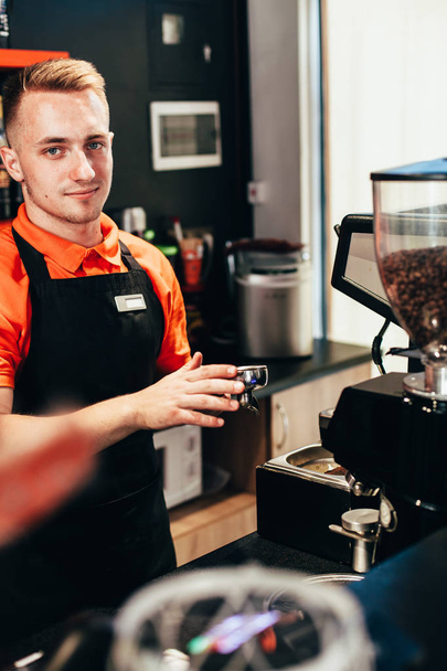 Barista makes delicious coffee in a coffee shop - Photo, Image