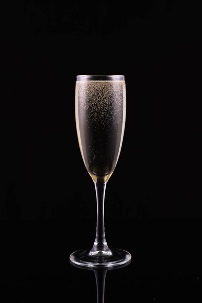 glass with white wine champagne on a black background - Foto, Imagem