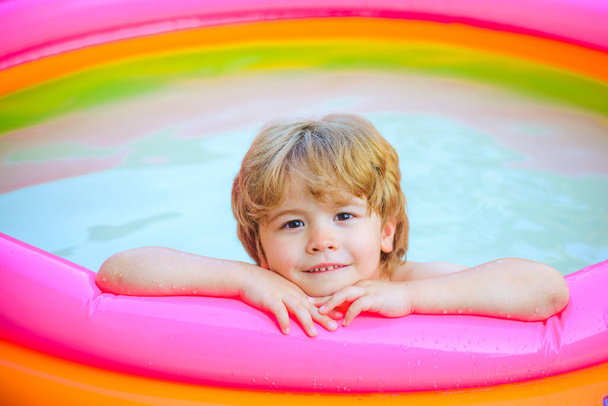 Children playing and active leisure - swimming pool concept. Child having fun in summertime. Little child boy having fun in the pool. Relax in spa swimming pool. Kids happy. - Fotó, kép