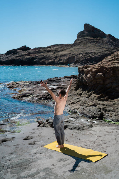 Handsome Man Yogi Practicing Yoga With Raised Arms (Sun Salutation) - Fotó, kép