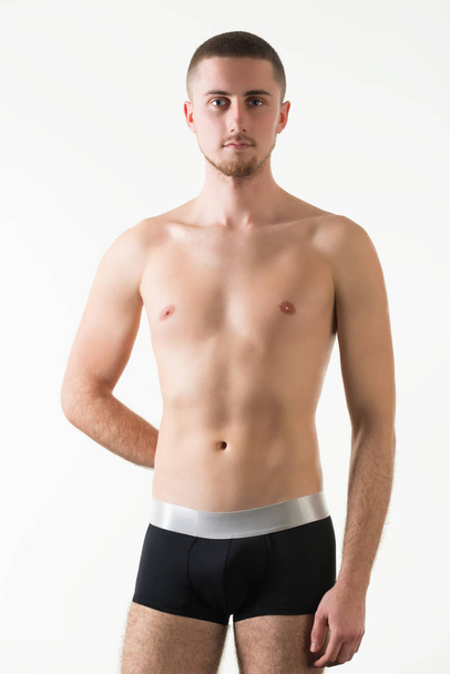 Young man in black mens underpants standing and looking at camera - Photo, Image