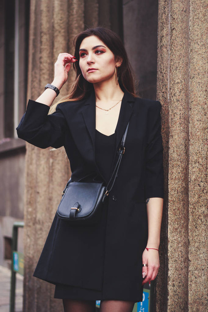 Model in black dress and long jacket. Style. Fashion trends 2020 - Zdjęcie, obraz