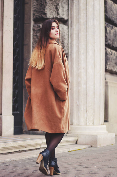 Model in black dress and long brown coat. Trench. Style. Fashion - Zdjęcie, obraz