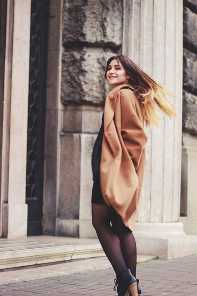 Model in black dress and long brown coat. Trench. Style. Fashion - Photo, Image