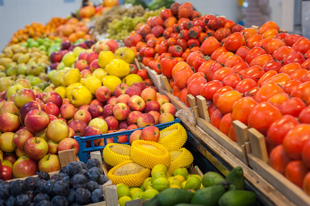 Fruit market with various colorful fresh fruits and vegetables - Фото, изображение