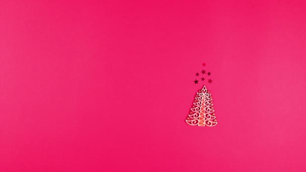 Concept of Christmas and New Year holiday and sale. Flat lay of wooden Christmas tree, confetti stars, cone and balls. Top view stop motion animation - Footage, Video