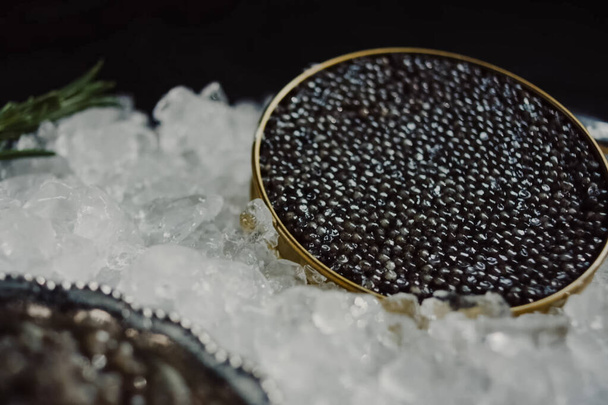 Black caviar served on table. Exquisite delicacy of black sturge - Photo, Image