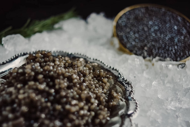 Black caviar served on table. Exquisite delicacy of black sturge - Photo, Image