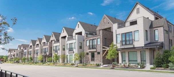 Na okraji parku se nachází nová řada tří povídkových rodinných domků v Richardson v severním Dallasu. Moderní design městských obytných domů s postranními soukromými dvory poblíž velké ulice a plotu - Fotografie, Obrázek