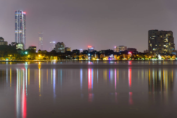 Hanoi skylines reflection at West Lake Ho Tay . Hanoi is capital of Vietnam. Colorful cityscapes and urban concept - Photo, Image