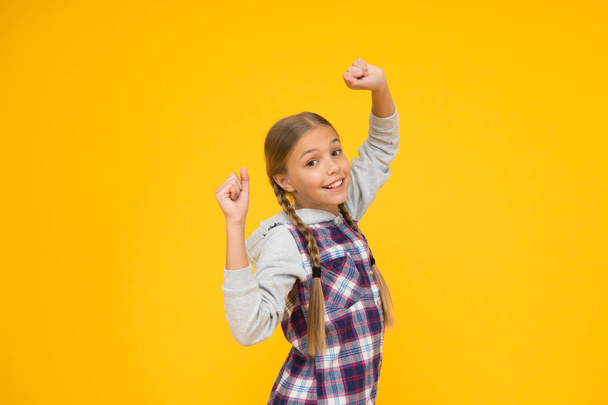 Happy international childrens day. Little girl yellow background. Good mood concept. Positive vibes. Sincere emotions. Having fun. Cute braided girl. Kid long hair. Small girl checkered shirt - Zdjęcie, obraz