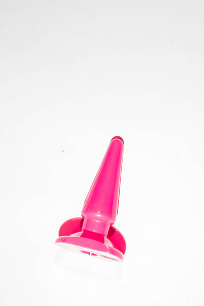 Juguete sexual sobre fondo rosa, vista superior, diseño plano con color f
 - Foto, Imagen