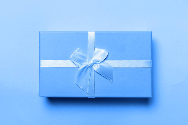 Small gift box colored in trendy color of year 2020 Classic Blue background. Bright Macro color 19-4052. Christmas New Year birthday valentine celebration present romantic concept - Φωτογραφία, εικόνα