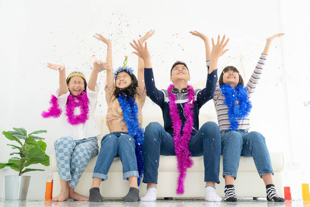 Group of children play with air balloons, confetti in light room - 写真・画像