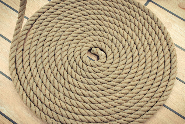 Thick rope wrapped in spiral on deck of ship - Foto, immagini