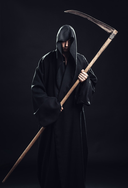 death with scythe standing in the dark - 写真・画像