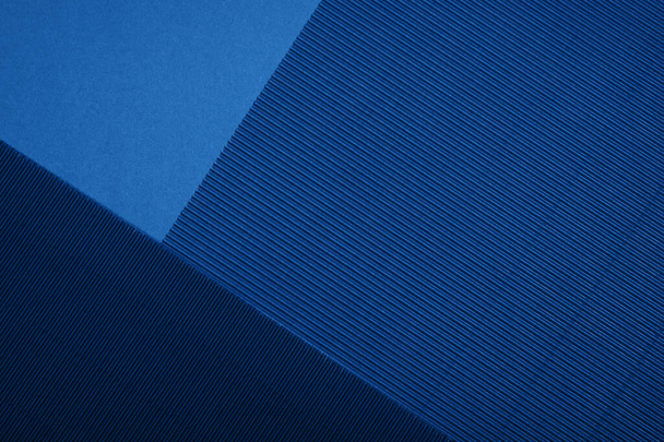 Abstract textured geometric paper in blue color background. - Photo, Image