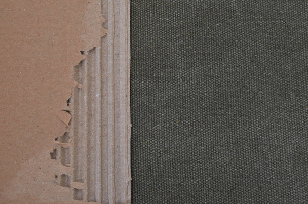 Background with black backdrop and torn corrugated cardboard. - Photo, Image