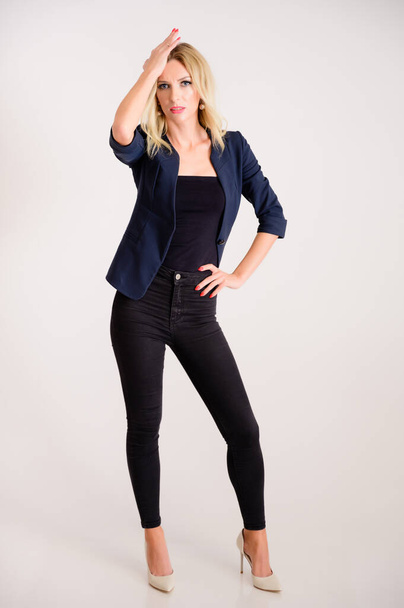 Business work concept. Full-length portrait of a pretty woman accountant - financier with excellent makeup, beautiful hair on a white background standing in front of the camera. - Foto, imagen