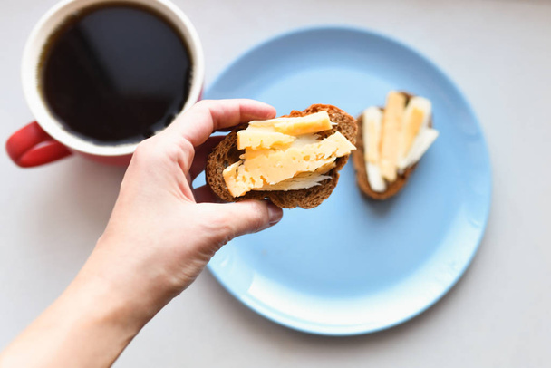 morning sandwiches with coffee. bread with cheese and butter. - Zdjęcie, obraz