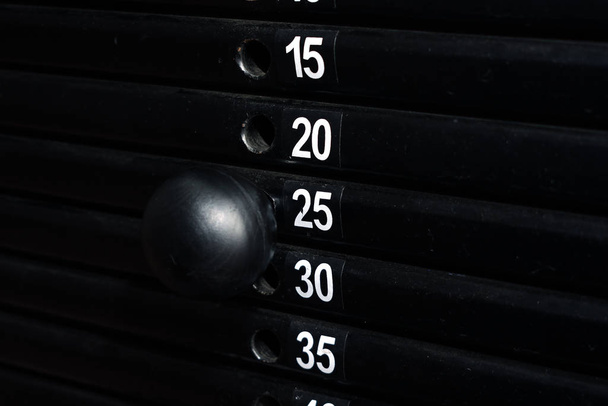 Twenty-five kilos weight set on a training machine. Pull strength training equipment. Close view. - Fotó, kép