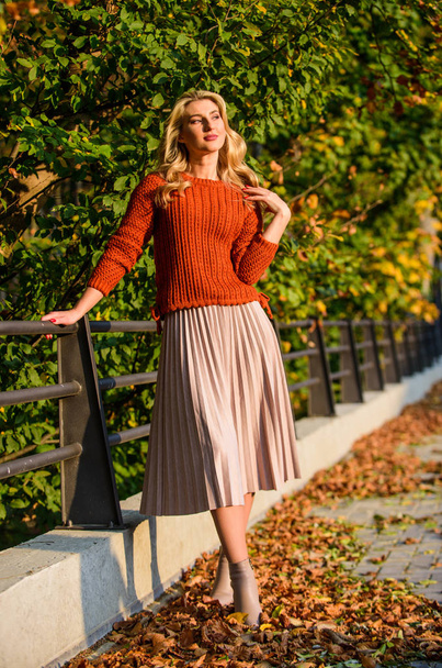 Pleated skirt fashion trend. Autumn stylish outfit. Fall fashion. Adorable lady enjoy sunny autumn. Fashionable clothes. Girl gorgeous blonde. Femininity and tenderness. Woman walking in autumn park - Fotó, kép